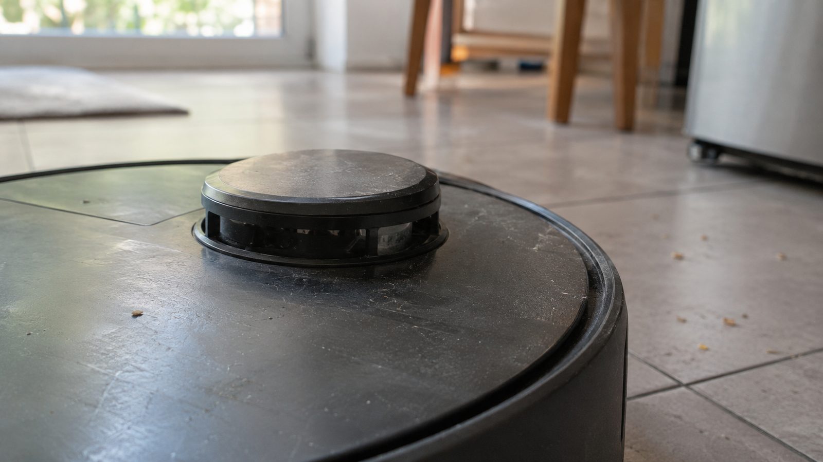 Close-up of the raised round laser scanner turret on top of a robot vacuum